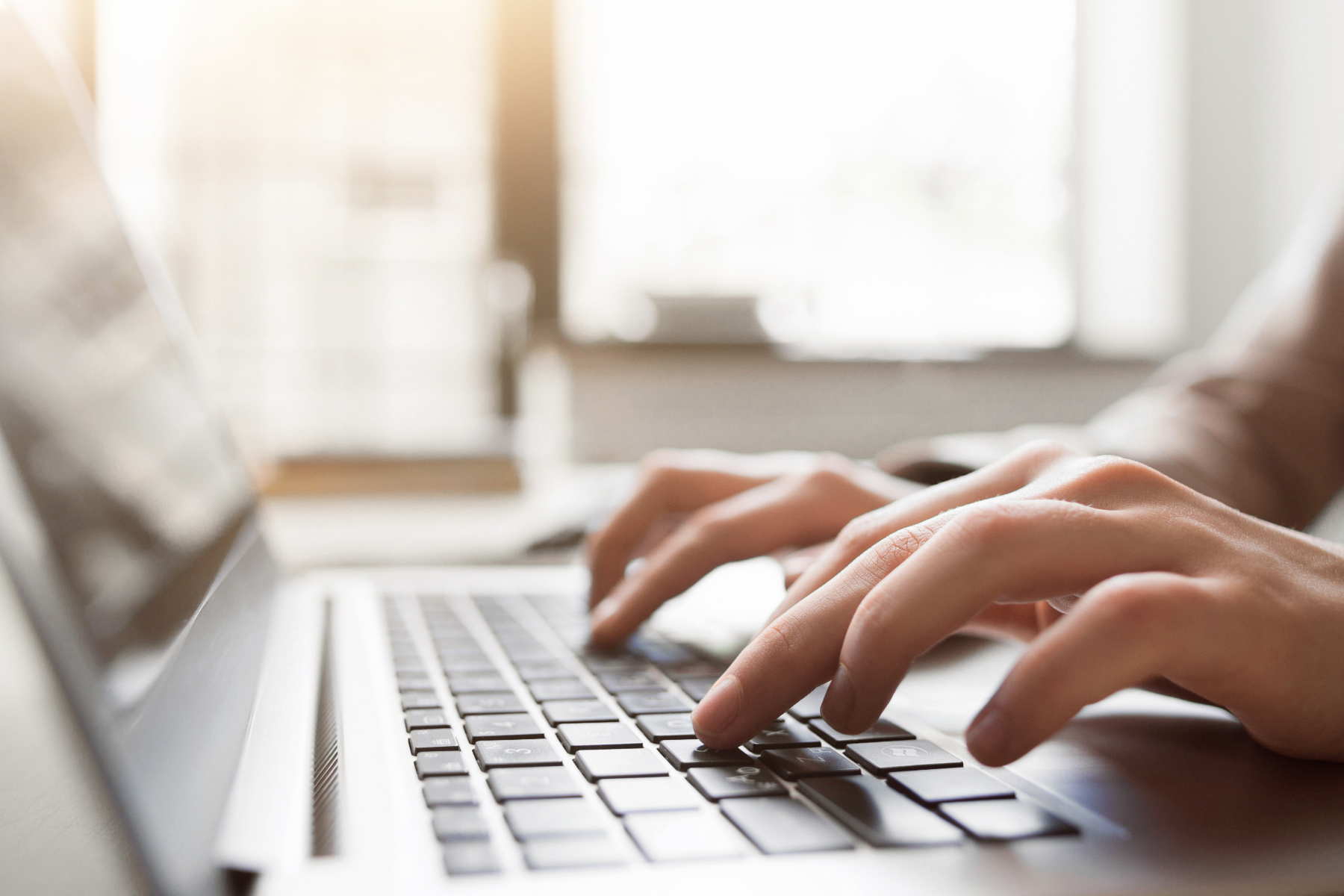 someone typing on a laptop